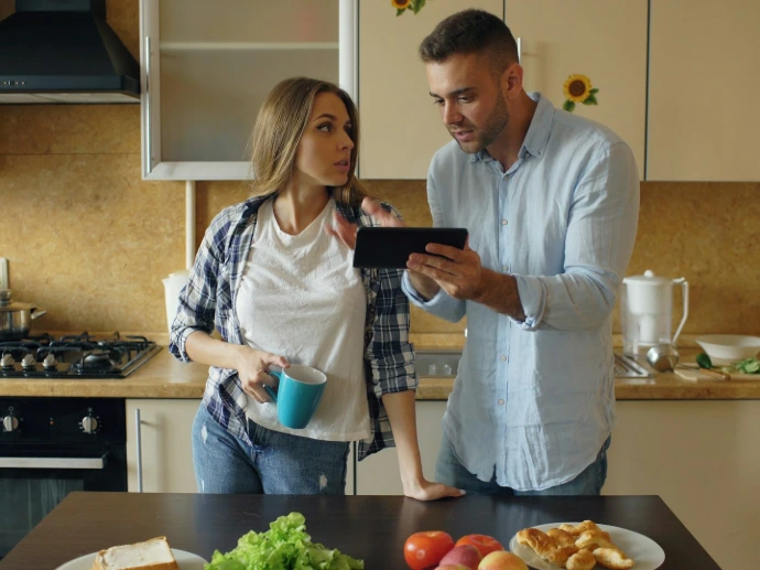 Couple looking at tablet in kitchen